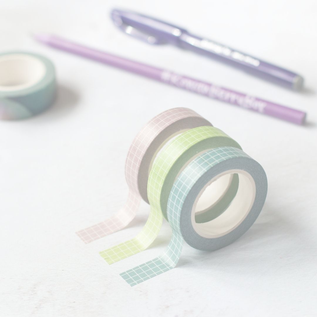 Pastel-colored washi tape with a pen on a light background