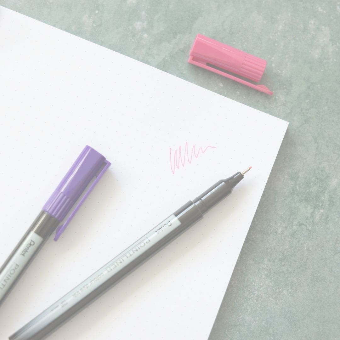 Two pens with purple and grey bodies on a white sheet of paper with a pink eraser.