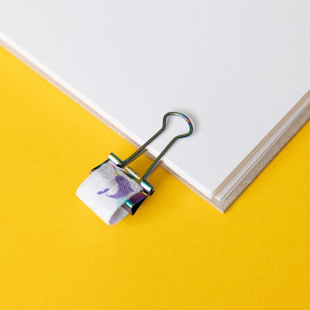 Narwhal elasticated pen loop on a yellow background